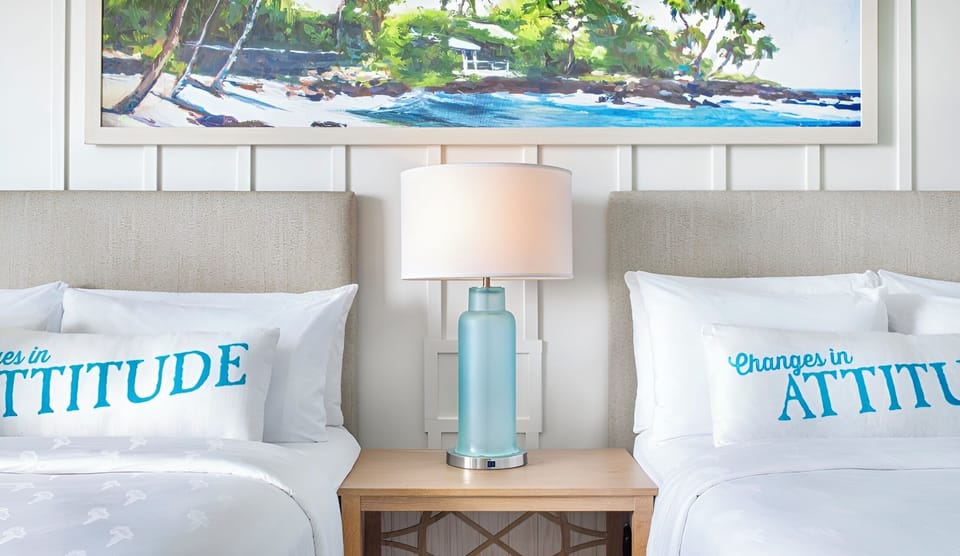 Drift off between soft headboards and warm bedside lighting.