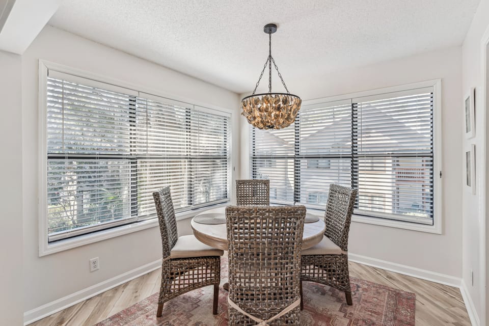 Gather around your elegant dining table where morning coffee conversations flow as naturally as the light streaming through panoramic windows.