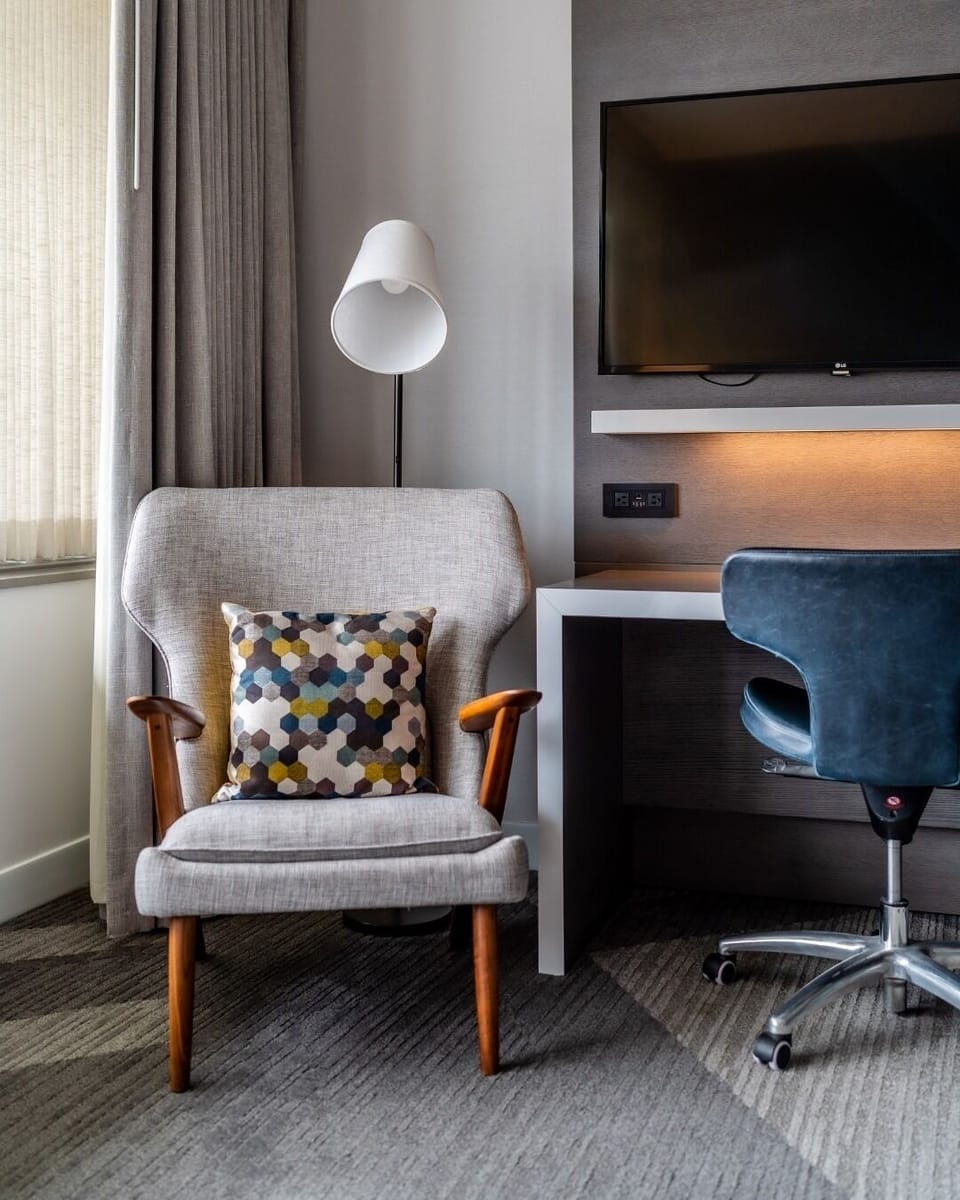 Settle in and focus at a sleek desk with TV.