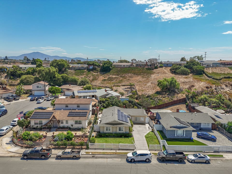 Single story home with mountains peeking out in the distance