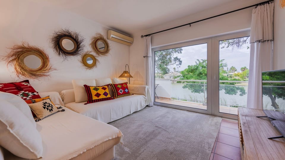 Spacious lounge area flooded with light, opening to a private lake-view balcony.
#relax #view #holiday #portugal #pt #troiapeninsula #soltroia