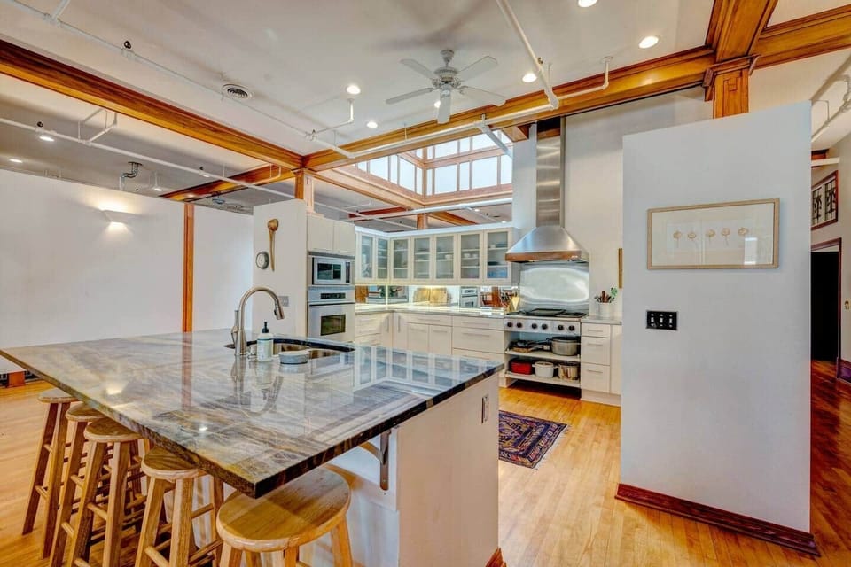 Cook like a pro in this chef's kitchen, featuring a spacious breakfast bar, Sub-Zero appliances, and top-notch equipment. Stocked for a private chef or for preparing a family meal, this kitchen blends functionality and style for any occasion. 
