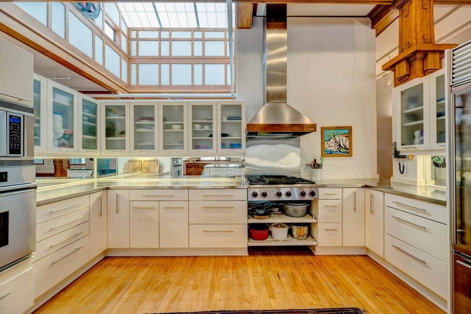 Brightened by a large skylight, this open-concept kitchen is a chef's dream. Thoughtfully designed with high-end features and ample space, it's perfect for culinary creations and seamless entertaining. 