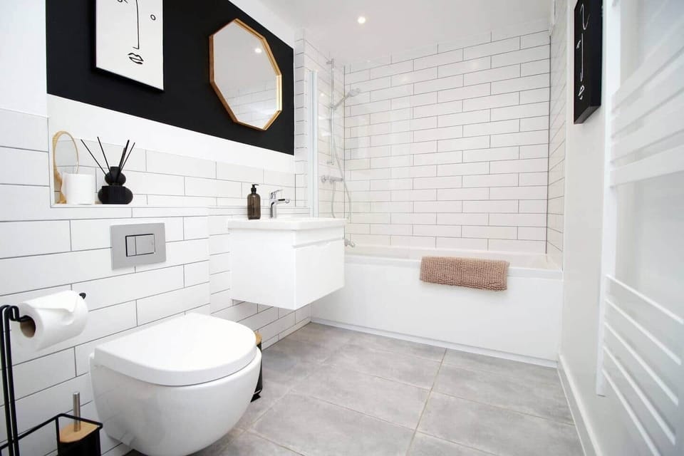 Modern, hotel-style bathroom with full bath and overhead rainfall shower. Finished with sleek fittin