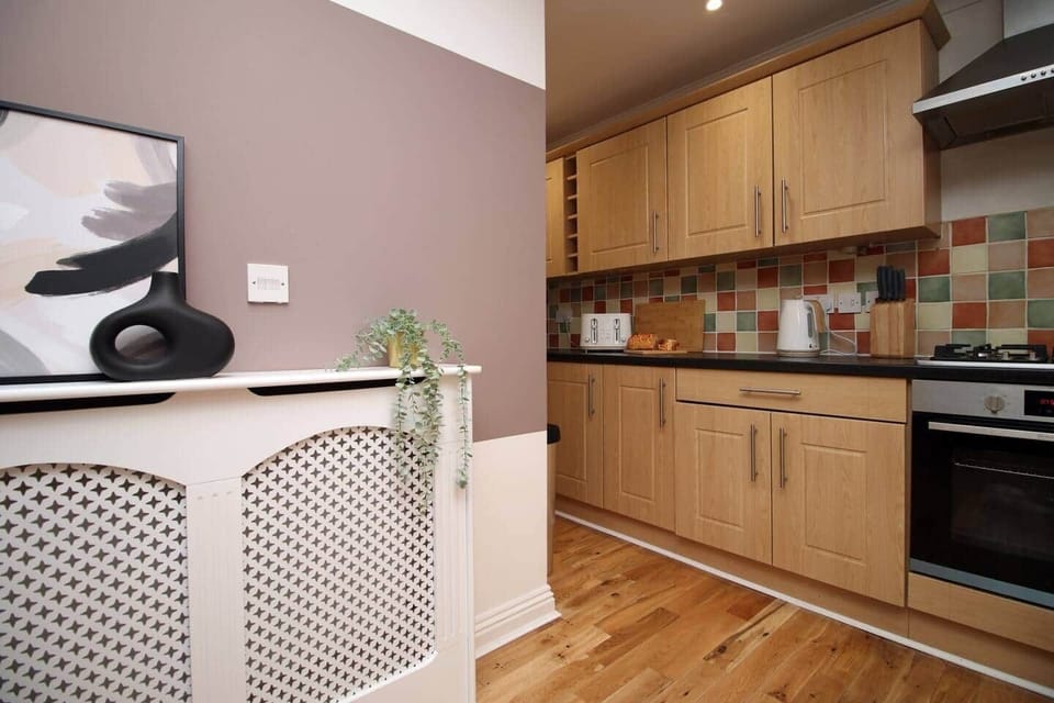 A stylish, fully equipped kitchen featuring modern appliances, spacious worktops and elegant cabinet