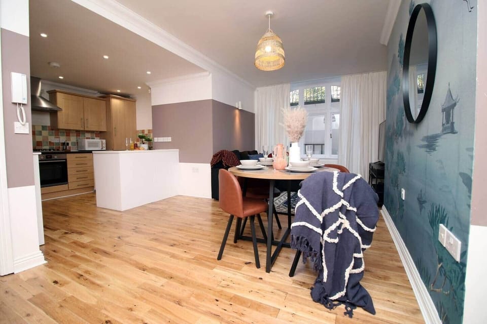 A beautifully styled dining area set within a bright, open-plan space. Featuring elegant décor, 