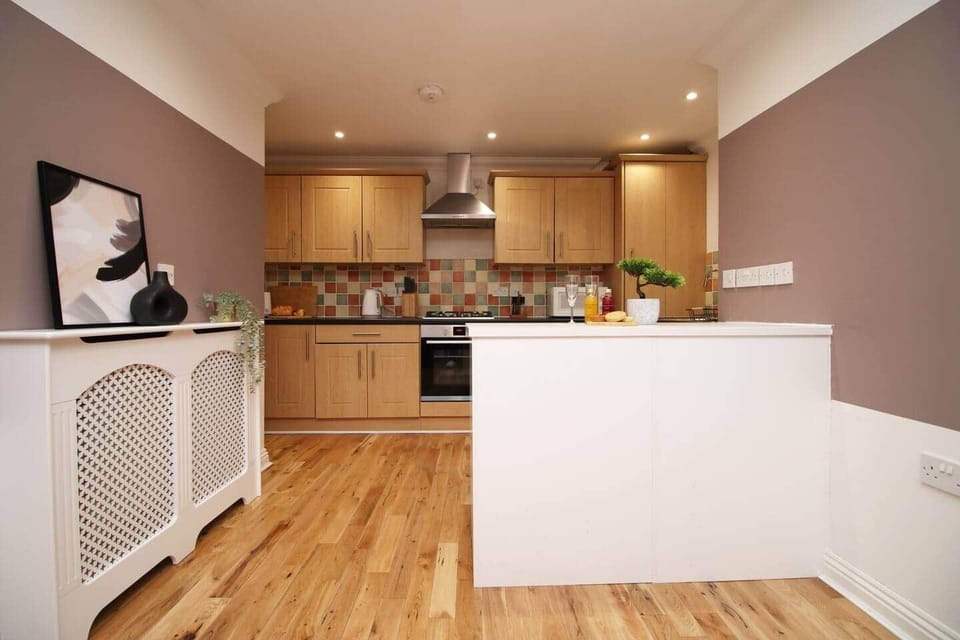 A stylish, fully equipped kitchen featuring modern appliances, spacious worktops and elegant cabinet