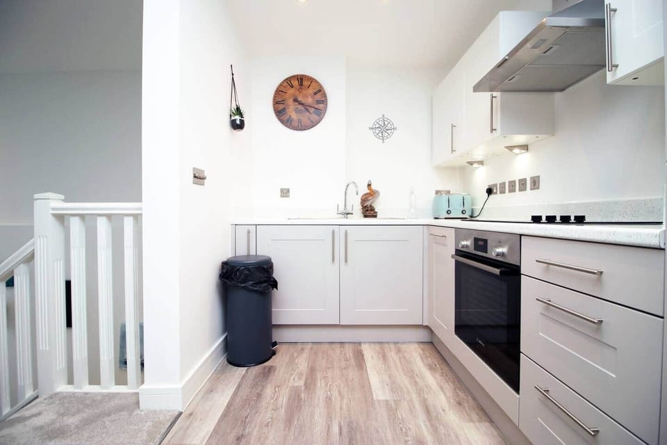 This bright, open kitchen offers generous counter space, modern appliances, and a stylish layout,