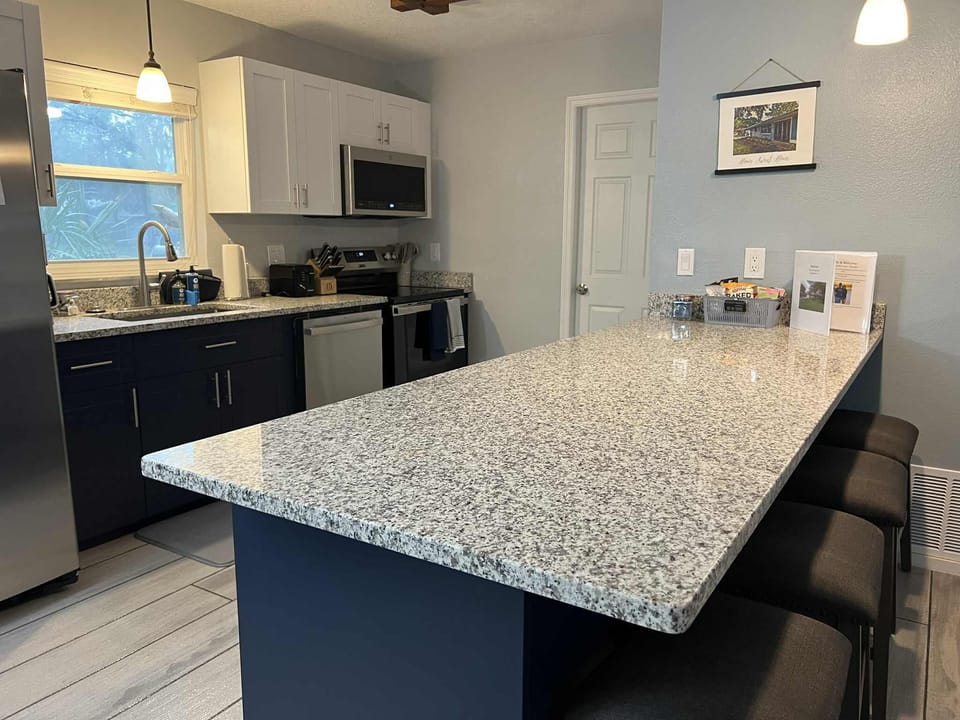 Kitchen includes dishwasher, stove, oven, microwave, fridge, and freezer