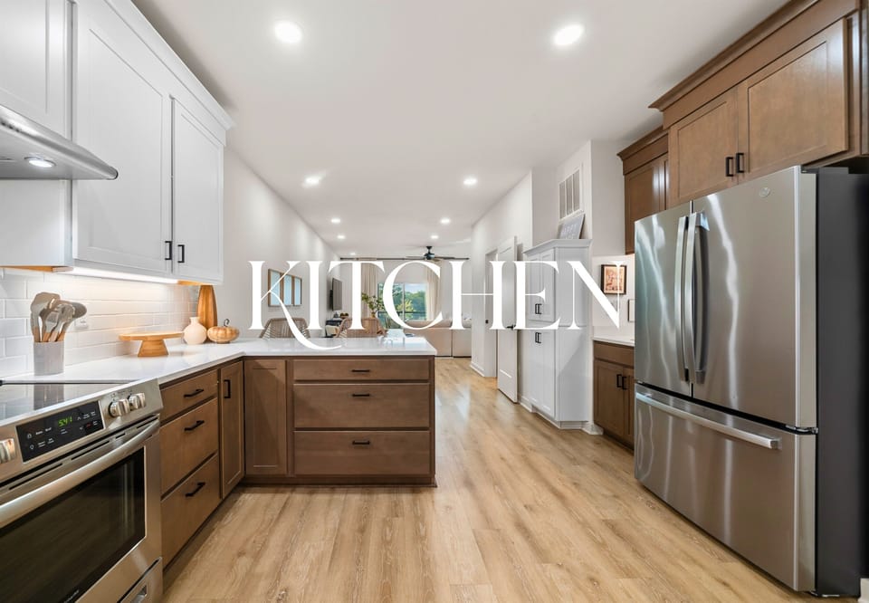 Modern kitchen fully equipped with stainless steel appliances and spacious countertops for effortless cooking.