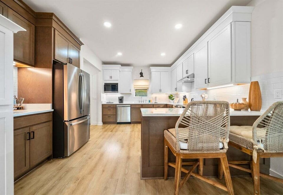 Inviting kitchen island with bar seating for casual dining or morning coffee gatherings.