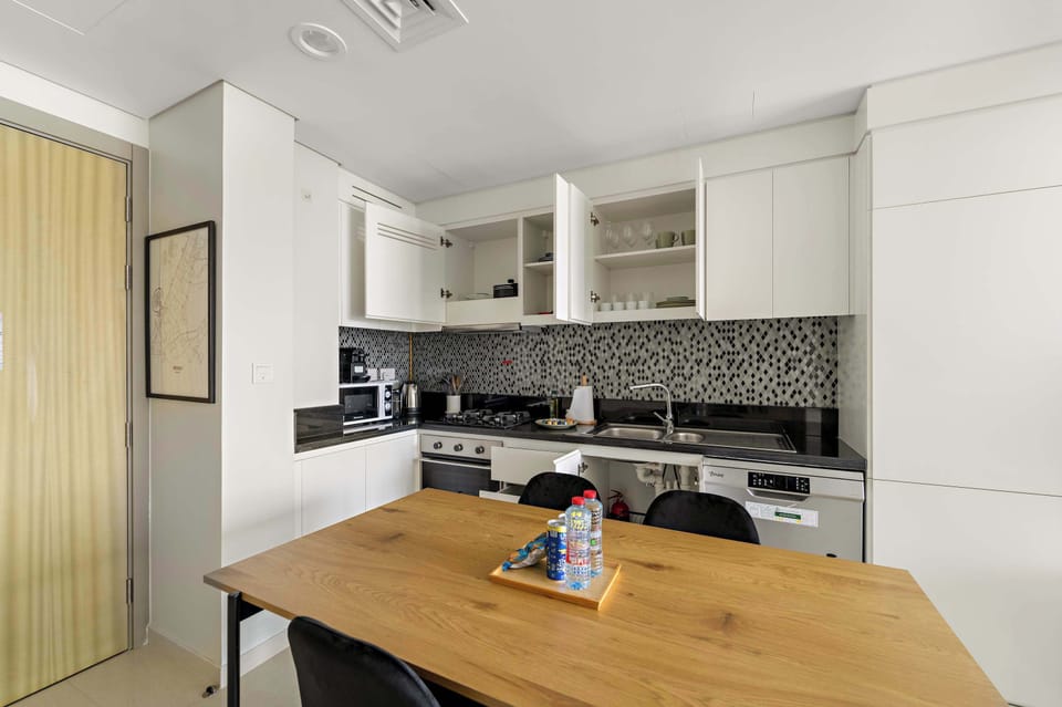 Enjoy meals in a sleek dining space beside the kitchen.