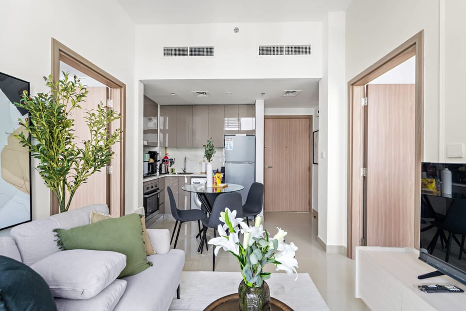 Stylish living room w/ neutral tones & greenery