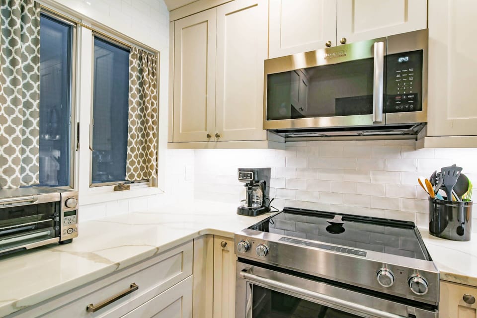 The kitchen has a drip coffee maker, toaster oven, microwave and range.
