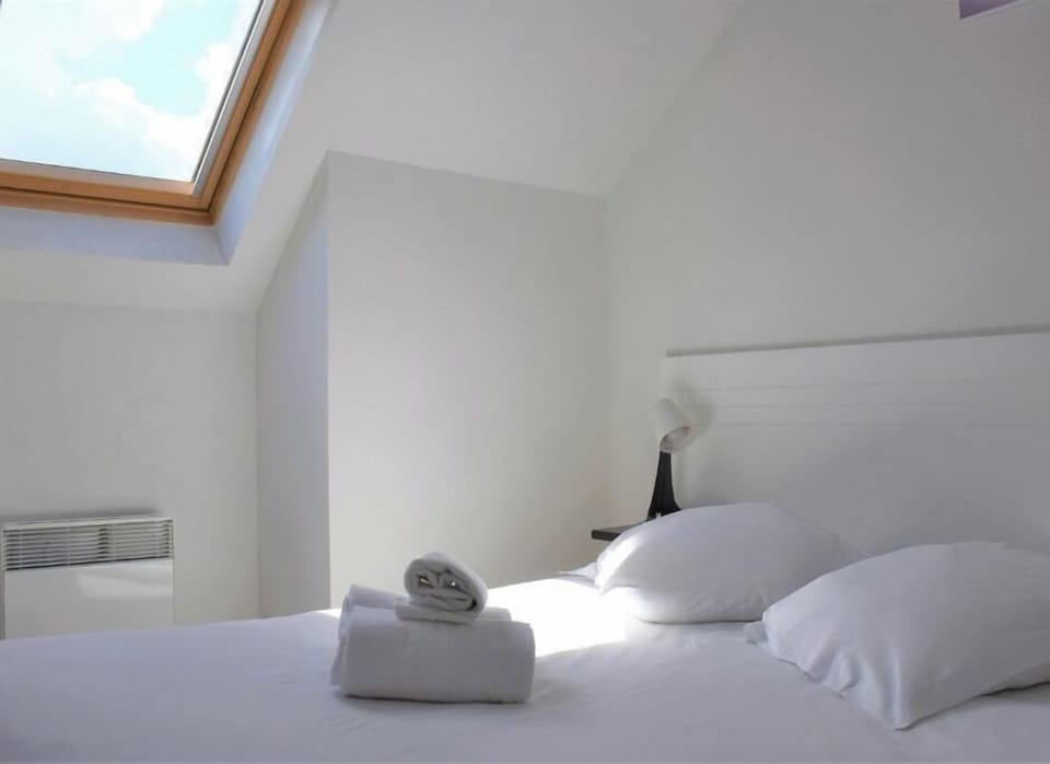 Wake slowly in sunlit comfort beneath the skylight glow.