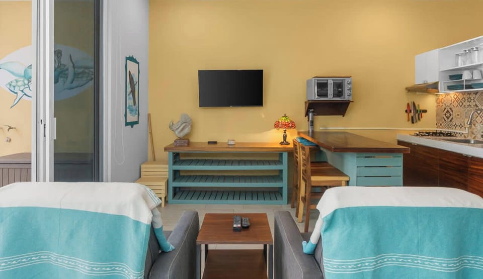 Living area with a sofa and TV space.