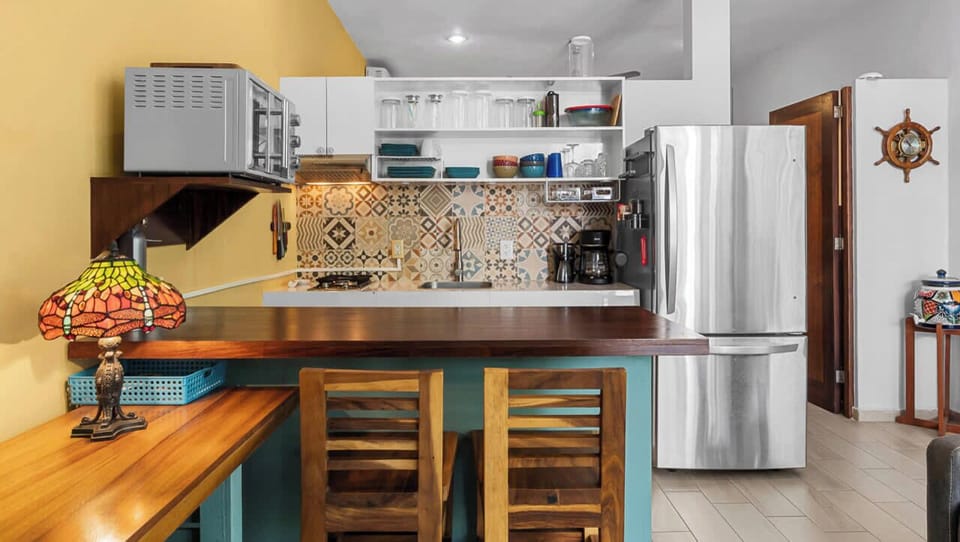 Practical kitchenette with essentials and a breakfast bar.