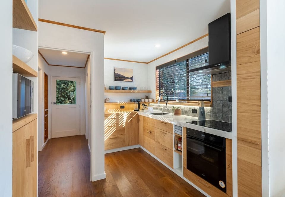 Fully equipped kitchen with oven, stove, microwave, fridge, and all the essentials for home-cooked meals