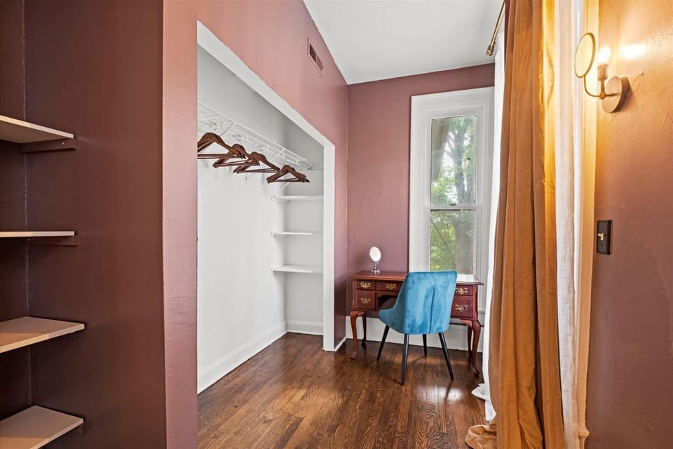 Thoughtfully designed king suite with an adjacent dressing area and workspace with open shelving, providing added space and comfort for extended stays.
