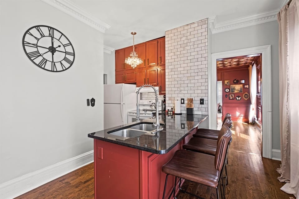Oversized kitchen island with seating for casual meals or entertaining, offering an open flow into the dining and living areas.