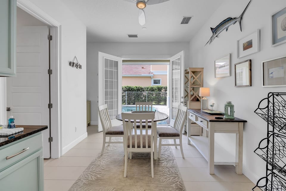 Indoor dining with French doors that open directly to the pool patio