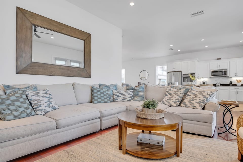 Large sectional sofa and open layout create a welcoming space for relaxing with family and friends