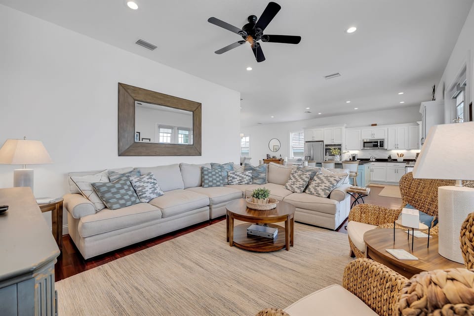 Relax in the bright, open living room with plush seating and coastal-inspired style