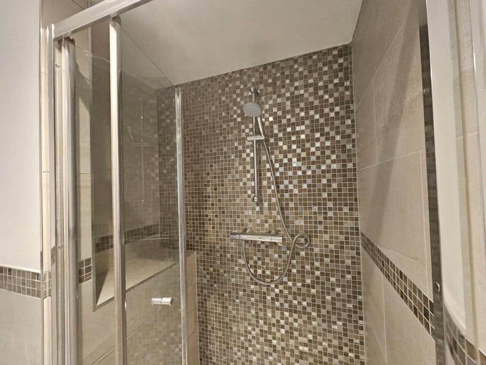 Beautiful bathroom with spacious walk-in shower, complete with underfloor heating