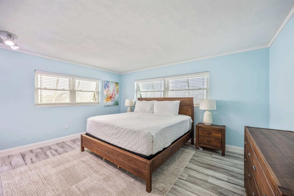 Bright bedroom with wooden furniture and light blue walls