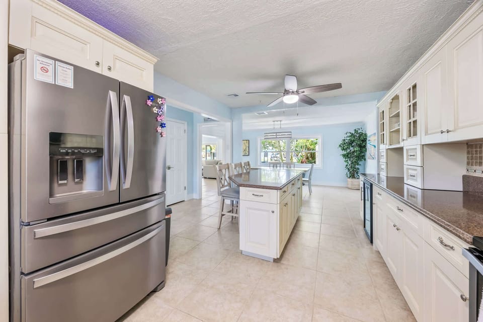 Spacious kitchen with modern appliances and a central island for dining.