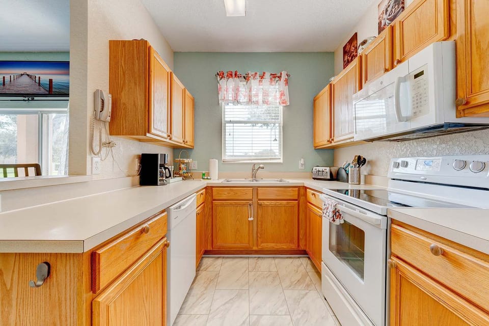 Bright kitchen with oak cabinets and modern appliances
