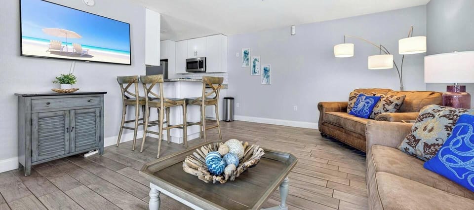 Steps to the beach, poolside condo, and cozy interiors!
