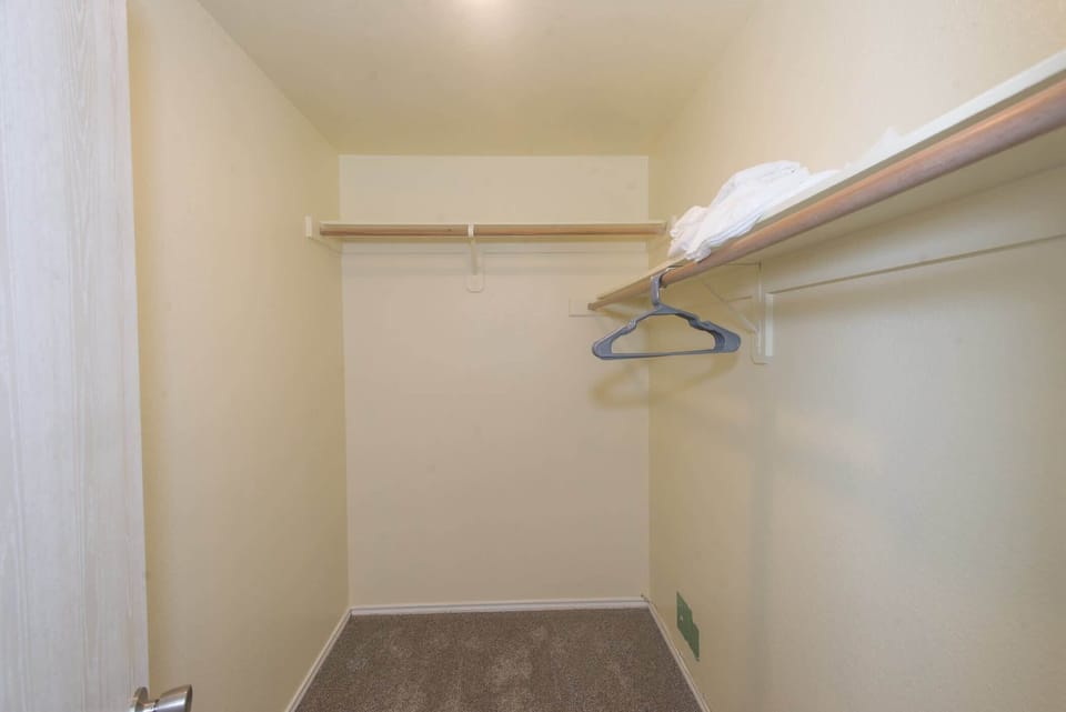 Keep clothes & bags tucked away in this spacious walk-in closet​