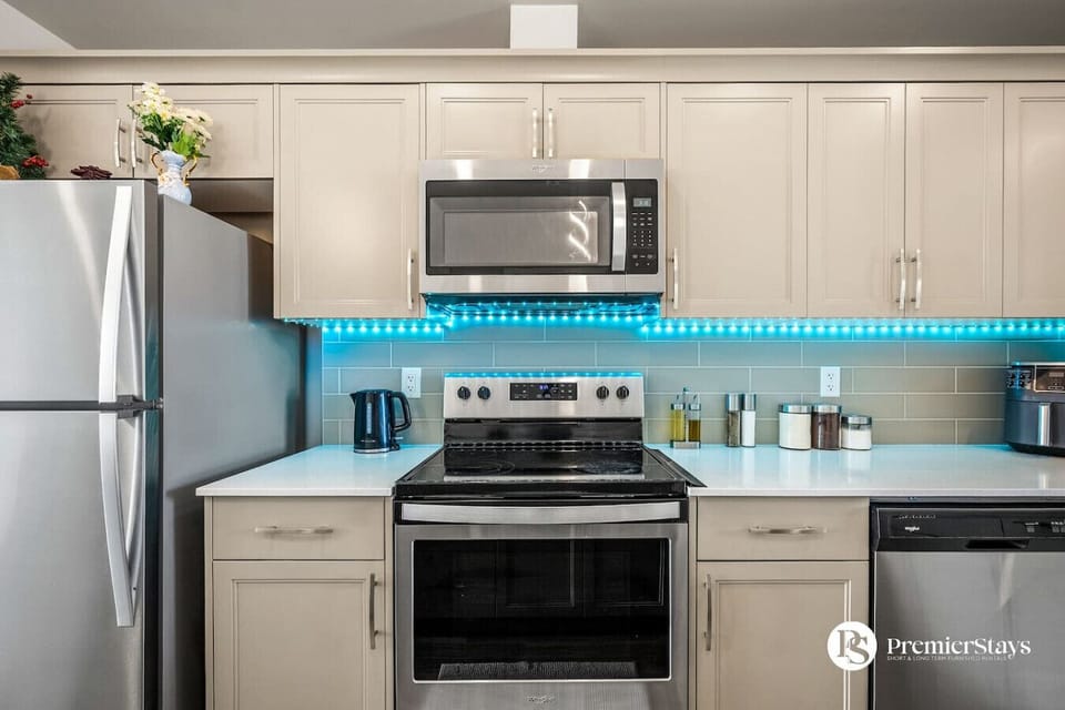 Fully equipped kitchen with stainless steel appliances and contemporary design