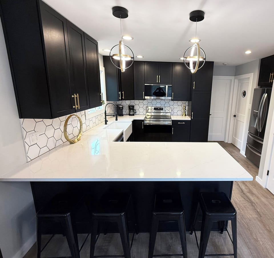 Sleek modern kitchen at Moon Mountain Manor with large countertop & bar seating.
