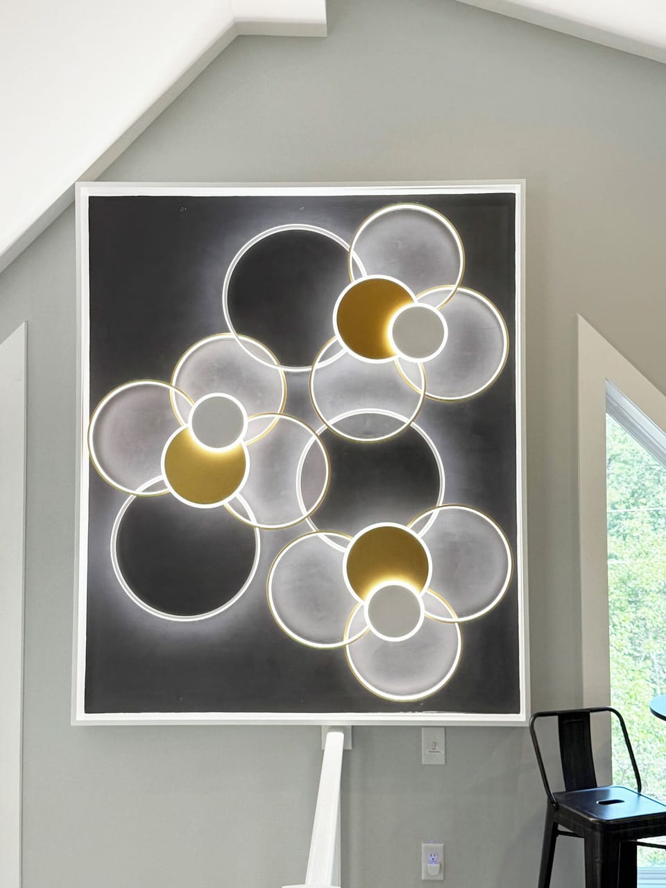 Modern custom wall decor lights up the third-floor loft at Moon Mountain Manor.