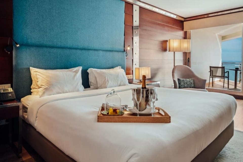 Unwind in crisp linens with sparkling sea views ahead.