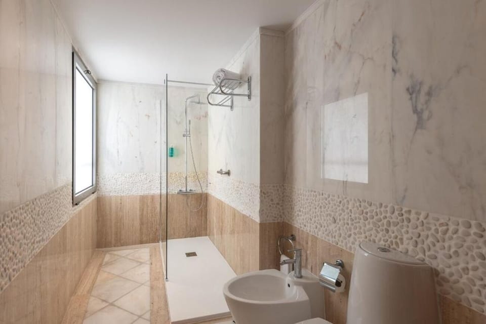 Rinse off in a sleek walk-in shower with rainfall feel.