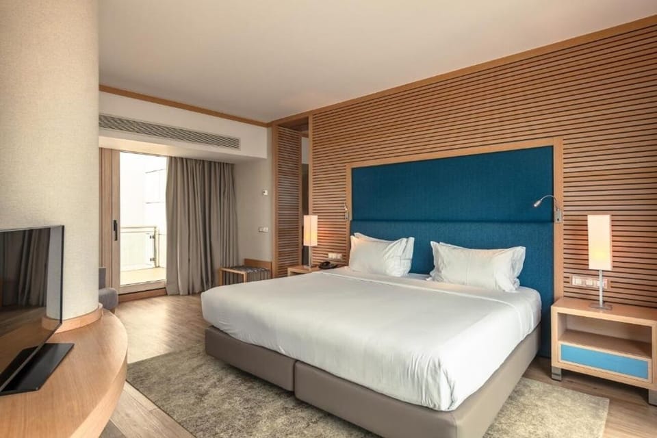 Unwind in a serene bedroom framed by warm modern design.