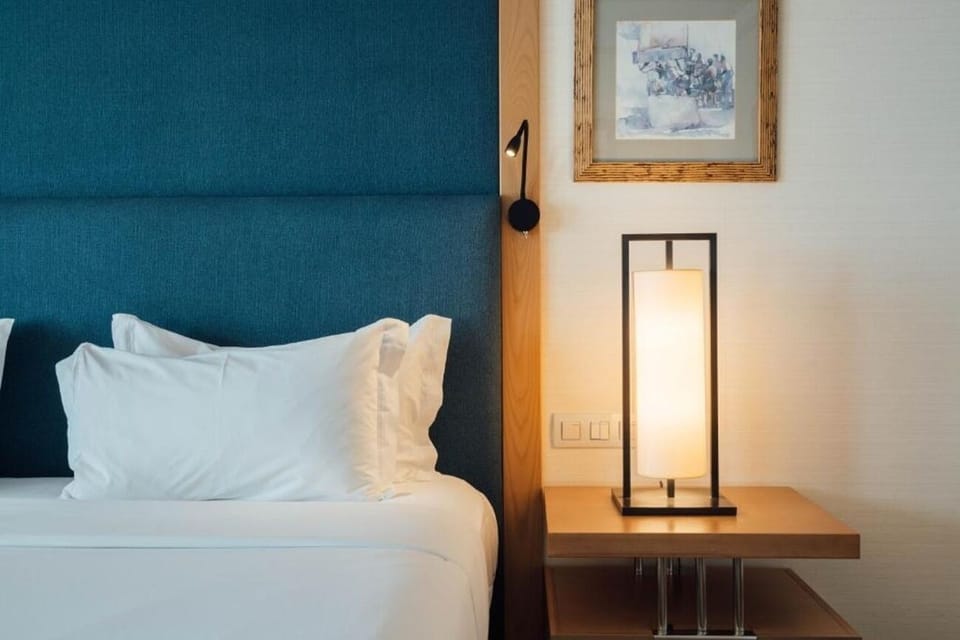 Drift off beside warm lighting and plush pillows.