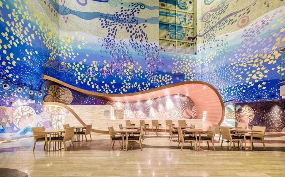 Gather for leisurely meals beneath dazzling, ocean-inspired mosaic walls.