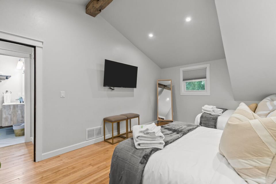 Smart TV and full-length mirror for easy entertainment and getting ready.