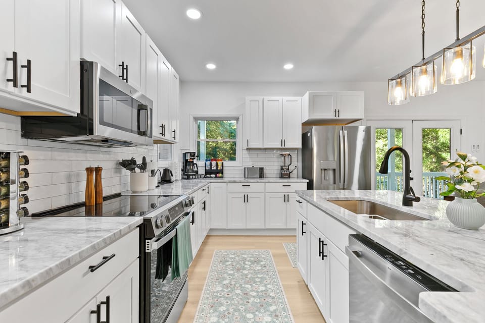 Fully stocked kitchen with cookware, dishes, utensils, coffee station