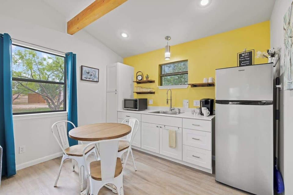 Seating for three and kitchenette.