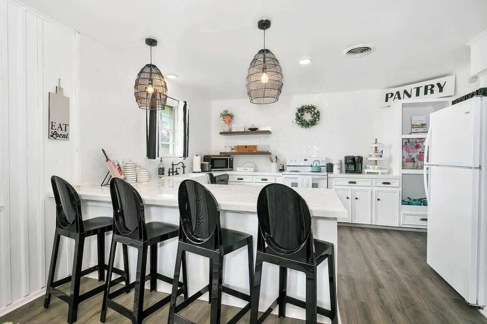 Enjoy the perfect blend of style and function in our farmhouse-style kitchen with bar seating, all the essentials you need, and an electric stove for easy cooking.