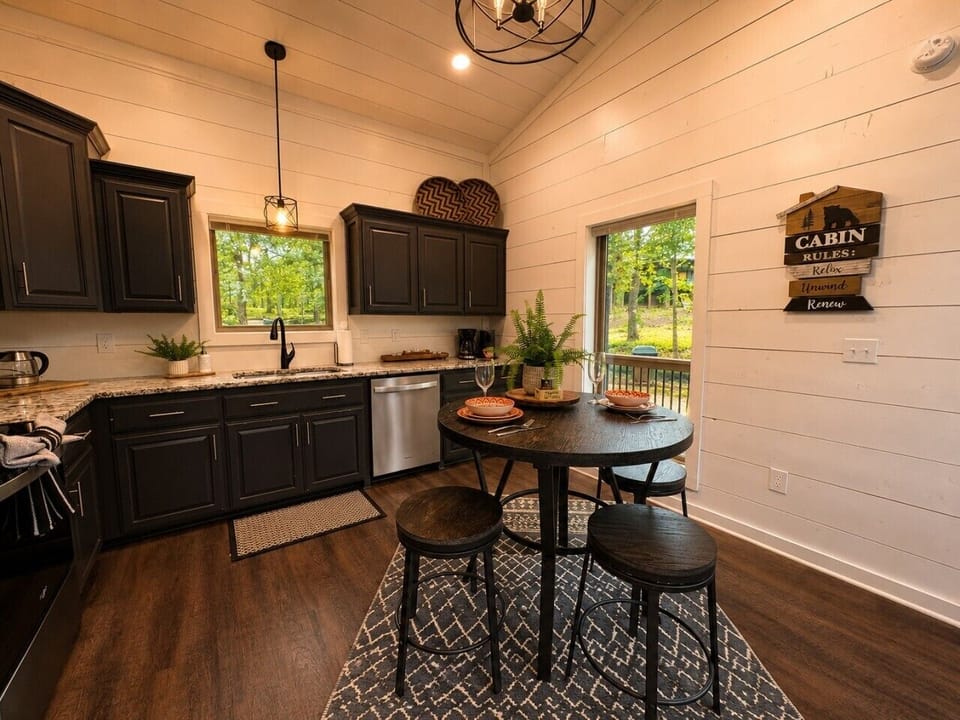 Fully equipped kitchen with dining space and peaceful forest views