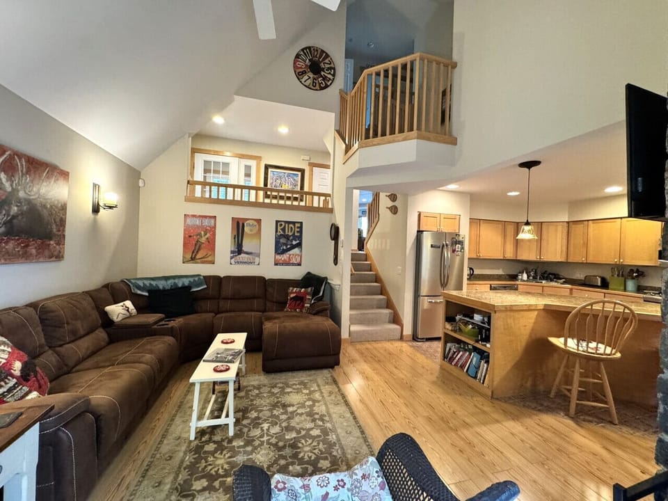 Open concept living with wood burning fireplace