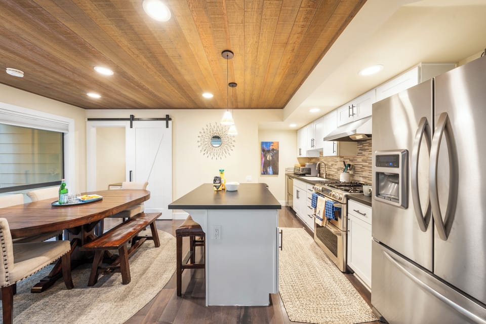 Dining and kitchen area with barstool seating.