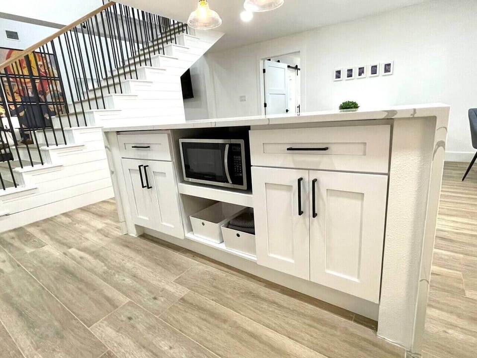 Microwave and extra dish towels located in kitchen island