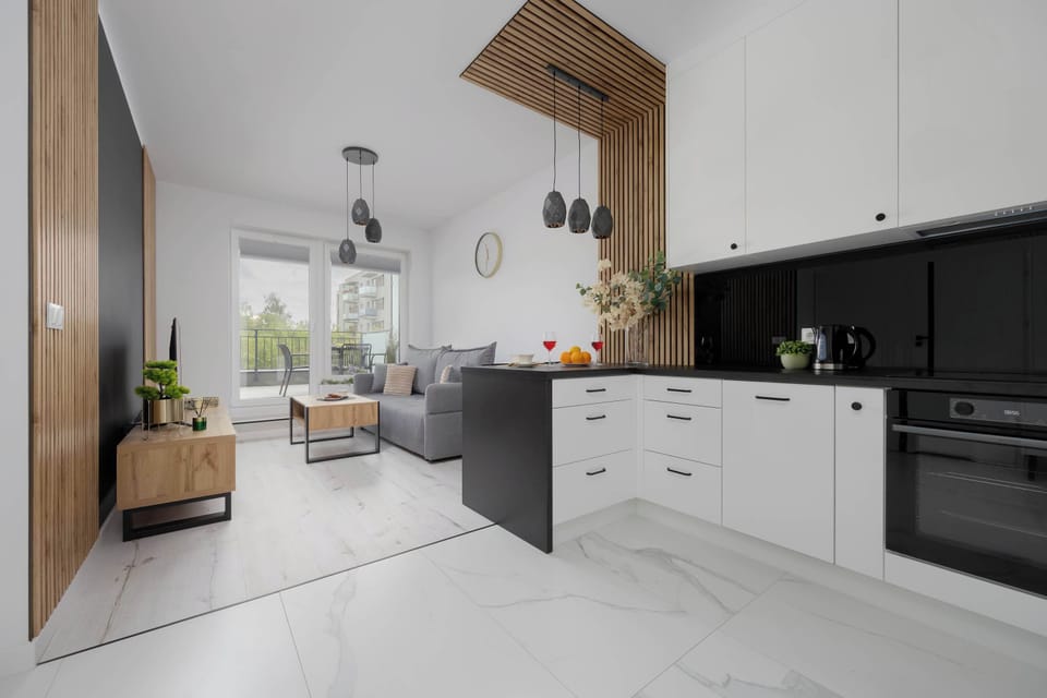 The open-plan kitchen and living room are designed to combine the convenience of cooking with the ease of conversation and socializing at the table.